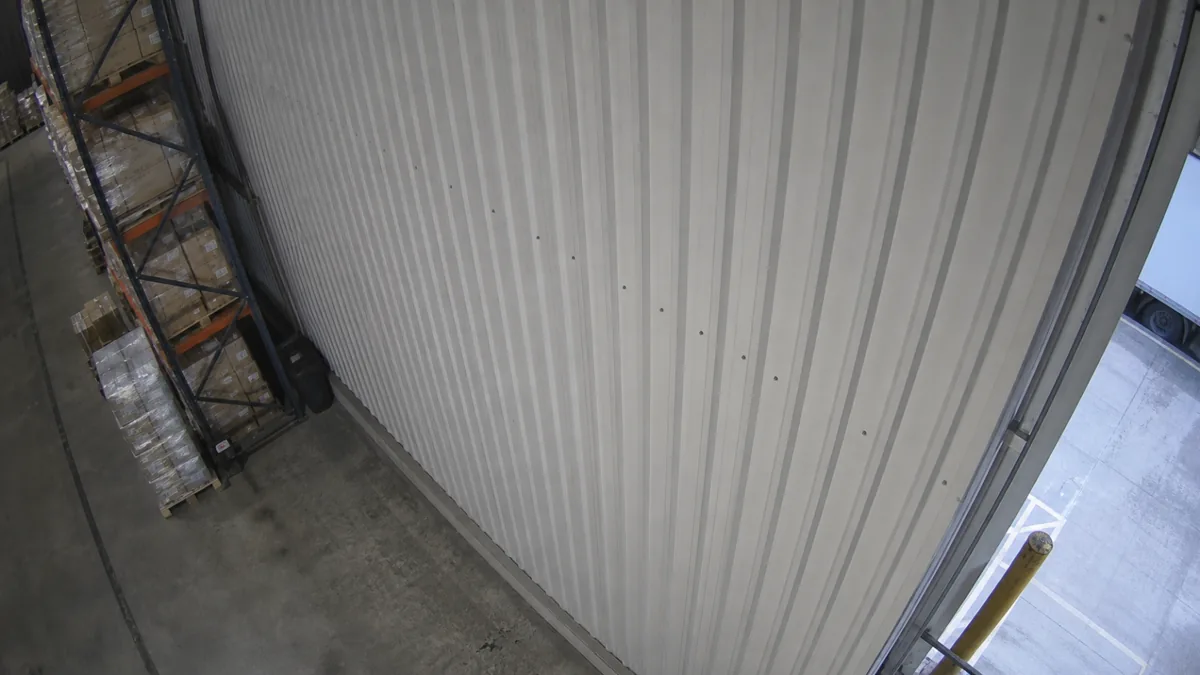 Scene change degradation in a loading dock CCTV view, where the camera points mostly at a corrugated wall.