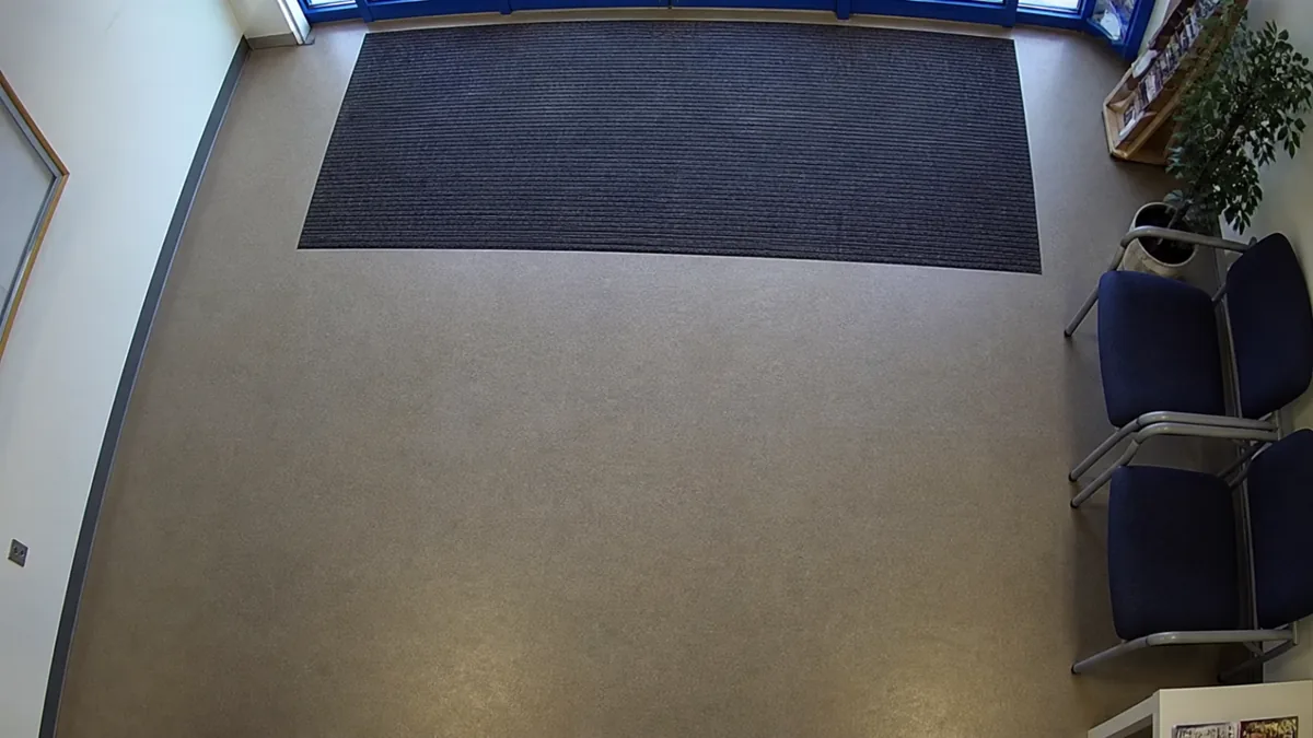 Scene change degradation in a reception CCTV view, where the camera points too low and misses the doorway.
